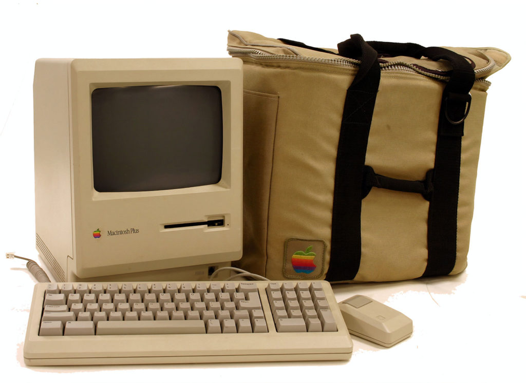 Early Macintosh Plus computer with its carrying bag.